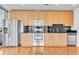 Bright kitchen featuring stainless steel appliances, sleek black countertops, and ample cabinet space at 777 N Ashley Dr # 1915, Tampa, FL 33602