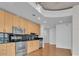 Well-lit modern kitchen equipped with stainless steel appliances, dark backsplash, and ample wood cabinetry at 777 N Ashley Dr # 1915, Tampa, FL 33602