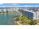 Stunning aerial view of the waterfront building complex, lush landscaping, and sparkling bay at 7892 Sailboat Key S Blvd # 107, South Pasadena, FL 33707