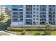 Condo building exterior featuring multiple balconies with seating areas and lush landscaping at 7892 Sailboat Key S Blvd # 107, South Pasadena, FL 33707