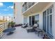 Enjoy the view from this balcony with wicker furniture and potted plants at 7892 Sailboat Key S Blvd # 107, South Pasadena, FL 33707
