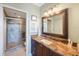 Bathroom features vanity with granite counters and a glass enclosed shower at 7892 Sailboat Key S Blvd # 107, South Pasadena, FL 33707