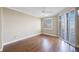 Bedroom with hardwood floors, large windows, and plantation shutters at 7892 Sailboat Key S Blvd # 107, South Pasadena, FL 33707
