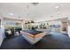Bright game room featuring two billiard tables, ample natural light, and comfortable seating area at 7892 Sailboat Key S Blvd # 107, South Pasadena, FL 33707