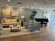 Comfortable living room area with neutral colors, a piano, and cozy seating arrangement at 7892 Sailboat Key S Blvd # 107, South Pasadena, FL 33707