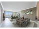 Spacious living area with balcony access, modern furniture, and dining area at 7892 Sailboat Key S Blvd # 107, South Pasadena, FL 33707