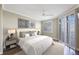 Bedroom featuring a ceiling fan, hardwood floors, a plush bed, and waterfront views at 7892 Sailboat Key S Blvd # 107, South Pasadena, FL 33707