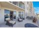 Spacious outdoor patio with comfortable seating and views of the building and sky at 7892 Sailboat Key S Blvd # 107, South Pasadena, FL 33707