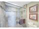 Walk-in shower featuring updated tile work, built-in bench, and a glass enclosure at 7892 Sailboat Key S Blvd # 107, South Pasadena, FL 33707