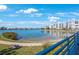 Tranquil waterfront scene featuring lush lawns and a bay view from along the walkway at 7892 Sailboat Key S Blvd # 107, South Pasadena, FL 33707