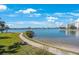 Scenic view of the waterfront with a paved path and lush landscaping at 7892 Sailboat Key S Blvd # 107, South Pasadena, FL 33707