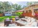 Backyard with a comfortable lounge area set on a wooden deck with a privacy fence at 907 E Hamilton Ave, Tampa, FL 33604