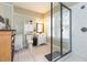 Charming bathroom with a glass-enclosed shower, a toilet, a sink, and a decorative cabinet for storage at 907 E Hamilton Ave, Tampa, FL 33604