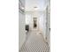 Bathroom with black and white tiled floors, white wainscoting, a toilet, and a large vanity at 907 E Hamilton Ave, Tampa, FL 33604