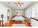 Spacious bedroom with wood floors, a large bed, and natural light pouring in from multiple windows at 907 E Hamilton Ave, Tampa, FL 33604