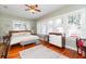 Airy bedroom featuring a large bed, a ceiling fan, and plenty of natural light from the surrounding windows at 907 E Hamilton Ave, Tampa, FL 33604