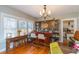 Dining area featuring a built-in bar, hardwood floors, and natural light from the windows at 907 E Hamilton Ave, Tampa, FL 33604