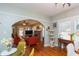 Bright dining area with a cat tree, hardwood floors, and easy access to the living room at 907 E Hamilton Ave, Tampa, FL 33604