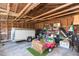 Spacious garage interior used for storage, including a trailer, shelves, and a toy car at 907 E Hamilton Ave, Tampa, FL 33604