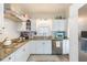 Beautiful kitchen with white cabinets, granite countertops, stainless steel appliances, and a subway tile backsplash at 907 E Hamilton Ave, Tampa, FL 33604