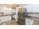 Bright kitchen features white cabinets, granite countertops, stainless steel appliances, and a stylish tile backsplash at 907 E Hamilton Ave, Tampa, FL 33604