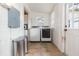 Functional laundry room featuring modern washer and dryer units, with ample space and storage at 907 E Hamilton Ave, Tampa, FL 33604
