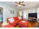 Bright living room with hardwood floors, comfy seating, and a television for relaxing entertainment at 907 E Hamilton Ave, Tampa, FL 33604