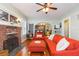 Inviting living room boasting hardwood floors, a fireplace, comfortable seating, and stylish decor at 907 E Hamilton Ave, Tampa, FL 33604