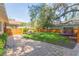 The property's fenced yard showcases lush landscaping and a well-maintained lawn at 907 E Hamilton Ave, Tampa, FL 33604