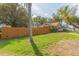 The property's fenced yard has a lush green lawn at 907 E Hamilton Ave, Tampa, FL 33604