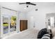 Bright main bedroom featuring closet, wood flooring, and sliding doors to private outdoor living area at 919 38Th Ne Ave, St Petersburg, FL 33704