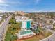 Aerial view of building's exterior with a private pool, parking and greenery under blue sky at 100 Waverly Way # 101, Clearwater, FL 33756