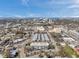 Expansive aerial view capturing the community, commercial areas, and a glimpse of the waterfront skyline at 100 Waverly Way # 101, Clearwater, FL 33756
