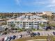 Exterior capture of the apartment complex showcasing spacious balconies, ample parking, and surrounding landscaping at 100 Waverly Way # 101, Clearwater, FL 33756