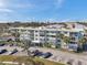 Exterior view of an apartment complex, with well-kept landscaping, balconies, and parking spaces available at 100 Waverly Way # 101, Clearwater, FL 33756