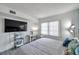 Bright and airy bedroom with a large window, desk, and built-in shelving at 100 Waverly Way # 101, Clearwater, FL 33756