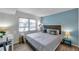 Relaxing bedroom with a large window, a desk, and calming blue accent wall at 100 Waverly Way # 101, Clearwater, FL 33756