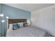 This cozy bedroom features a nautical theme and a calming blue accent wall at 100 Waverly Way # 101, Clearwater, FL 33756