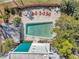 Aerial of community pool with lounge chairs, surrounded by trees and fence, offering residents outdoor relaxation space at 100 Waverly Way # 101, Clearwater, FL 33756