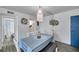Bright dining space with blue door, coastal wall art, and white seating at 100 Waverly Way # 101, Clearwater, FL 33756