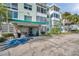 Inviting condo building featuring rock facade, well-manicured landscaping and an accessible entrance at 100 Waverly Way # 101, Clearwater, FL 33756