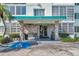 Inviting condo building featuring rock facade, well-manicured landscaping and an accessible entrance at 100 Waverly Way # 101, Clearwater, FL 33756