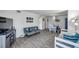 Open living room with wood-look floors, comfortable seating and dining area at 100 Waverly Way # 101, Clearwater, FL 33756