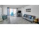 Comfortable living room with wood-look floors, comfortable seating and a balcony at 100 Waverly Way # 101, Clearwater, FL 33756