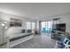Cozy living room with wood-look floors, a daybed, comfortable seating and a balcony at 100 Waverly Way # 101, Clearwater, FL 33756