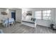 Bright living room with wood-look floors, comfortable seating and dining area at 100 Waverly Way # 101, Clearwater, FL 33756