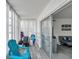 Light-filled sunroom connecting to living area, featuring comfortable seating with sliding glass door at 100 Waverly Way # 101, Clearwater, FL 33756