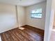 Bedroom with laminate wood floors, window and neutral walls at 103 W Wheeler Rd, Seffner, FL 33584