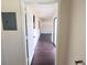 Hallway with wood floors leading to another room, and a circuit breaker at 103 W Wheeler Rd, Seffner, FL 33584