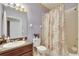 Full bathroom with a shower-tub combo, single sink vanity, and colorful decor at 10328 Celtic Ash Dr, Ruskin, FL 33573